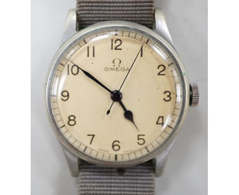 A gentleman's early 1940's stainless steel military issue Omega manual wind wrist watch, on fabric strap, the case back inscr