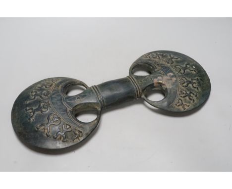 A decorated green patinated double bladed hand axe, 42cm long