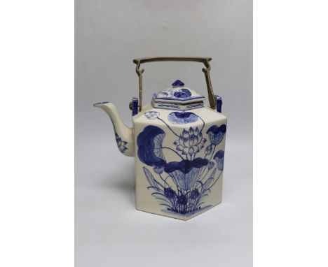 A Chinese blue and white oversized hexagonal teapot, with brass fitted handle and floral decoration, 30cm tall