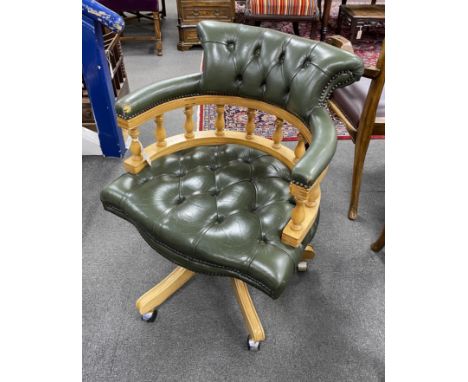 A reproduction buttoned green leather pale mahogany swivel 'captain's' desk chair, width 63cm, height 78cm