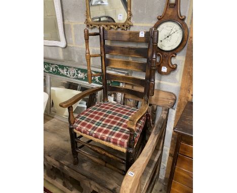 A 19th century provincial ash and elm rush seat ladder back elbow chair, width 58cm, height 108cm