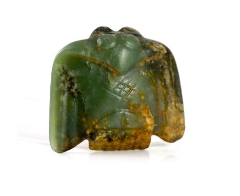 A Chinese archaic green and russet jade carving of a bat or bird, 5.5 cm wide