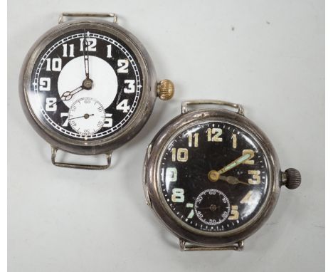 Two early 20th century silver manual wind wrist watches including black dial, both with subsidiary seconds, no straps.