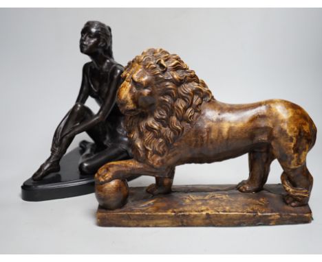 A bronze figure of a seated female dancer and a model of a lion, dancer 29cm high