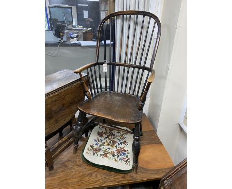 An early 19th century Windsor elm and beech comb back armchair, width 48cm, depth 43cm, height 110cm