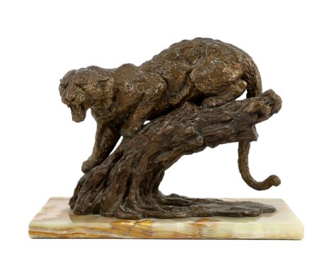 William Timym (British, 1902-1990). A bronze model of a jaguar crouched upon a tree trunk, signed in the bronze with Morris S