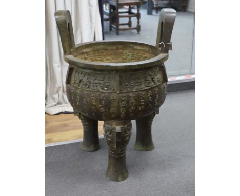 A massive Chinese bronze tripod vessel, ding, 85cm tall
