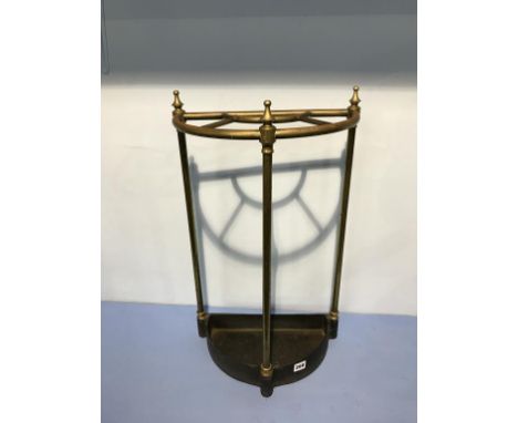 A brass half moon stick stand