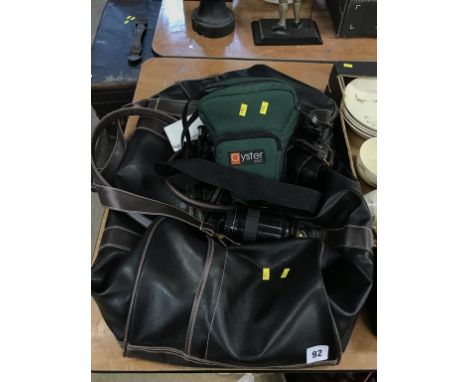A leather holdall and a camera