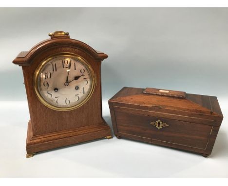 An Edwardian oak mantel clock and a rosewood tea caddy
