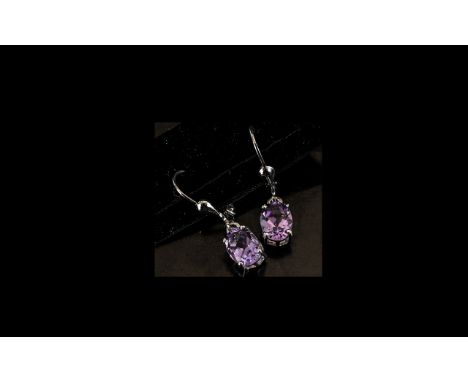Pair of Amethyst Drop Earrings, oval cut solitaire amethysts of 2cts, classically set, in platinum vermeil and silver with le