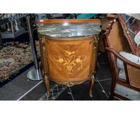 A French Style Bow Fronted Commode with shaped marble top, ormolu mounts and inlaid door.  Raised on short cabriole legs.  To