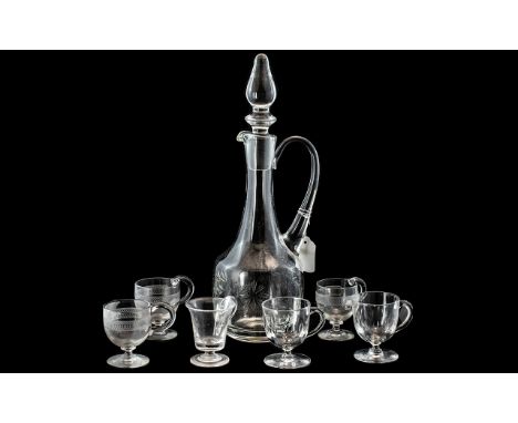 Glass Wine Decanter together with six glasses with handles and footed base.  Decanter has handle and ornamental stopper, and 