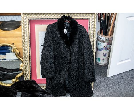 Beautiful Black Astrakhan Coat, with black mink collar, made by Raimond Furs of Manchester.  Button and hook fastening, shawl