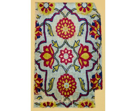A Mughal velvet fragment India, circa 1700the light blue ground with a red-outlined cartouche containing radiating flowerhead