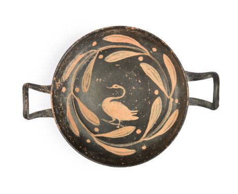 A Xenon Ware stemless kylix,  Possibly Apulian, 4th century BC., with a swan surrounded by a laurel wreath, with upturned han