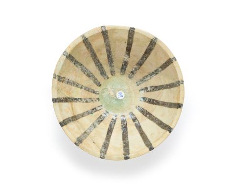 A black and white painted rounded pottery bowl,  Kashan, central Iran, 12th/13th century, On short foot, with flat lip, with 