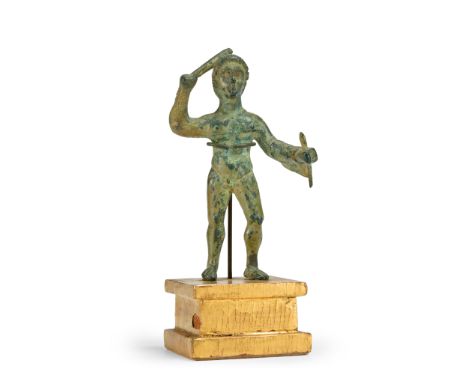 An Etruscan bronze figure of Herakles,   circa 3rd century B.C., the right arm raised holding a club, the lion skin over the 