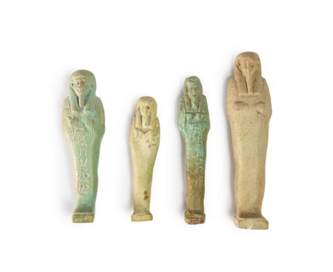 Four Egyptian faience shabtis,   Late Period after 600 B.C. the tallest uninscribed with implements and seedbag, 12.2cm high;
