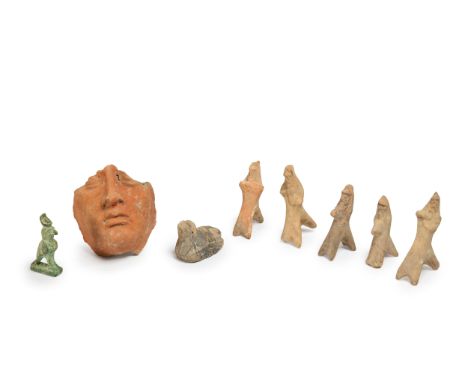 An Etruscan terracotta fragmentary hollow-backed head, circa 4th-3rd Century B.C., 13cm high, 12cm wide; five fragmentary and