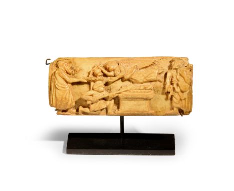 A Roman bone fragment,  circa 2nd-3rd Century A.D. carved with a temple scene, depicting a winged Nike above an altar, the fi