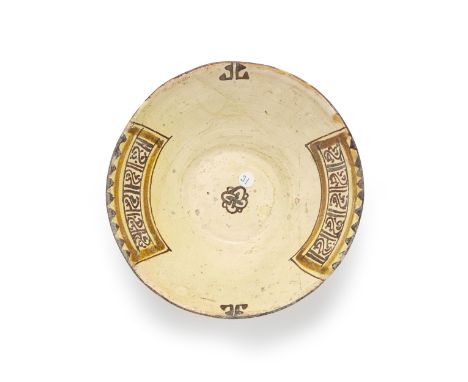 A small conical pottery bowl,  Nishapur, north east Iran, 10th century, On short foot, the base incised, the cavetto with a g