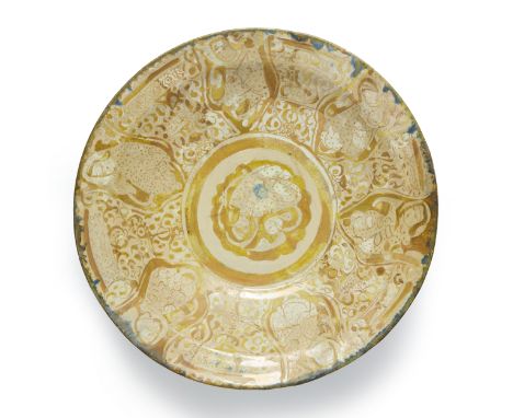 A large and shallow lustre and cobalt blue figural pottery charger,  Kashan, central Iran, 12th-13th century, On straight foo