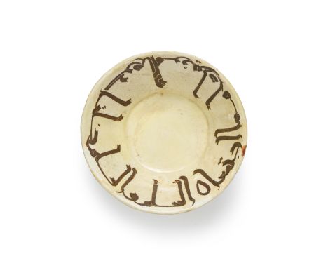 A Nishapur calligraphic conical pottery bowl, Central Asia, 9th/10th century, Rising from a near flat foot, the white walls i