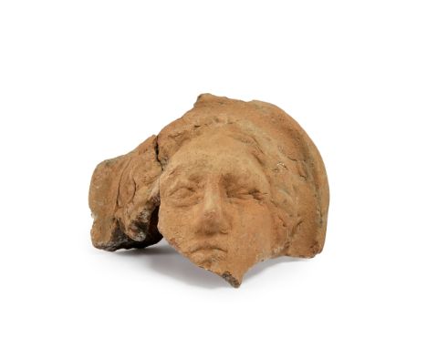 An Etruscan fragmentary terracotta votive female head,   circa 4th-3rd Century B.C., 16cm high, 18cm diamProvenance:Phillips 