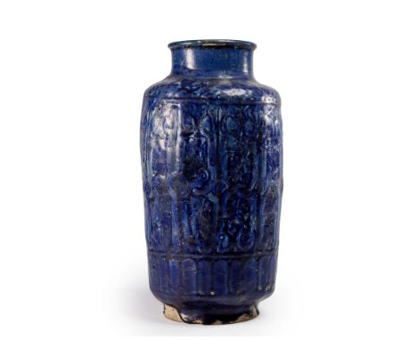 A large Kashan moulded cobalt blue glazed pottery albarello,  Central Iran, 13th centuryOf cylindrical form on short foot, th