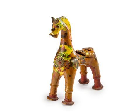 A splashware pottery standing figure of a horse,  Canakkale, Ottoman Turkey, 19th century, painted in brown, yellow and green