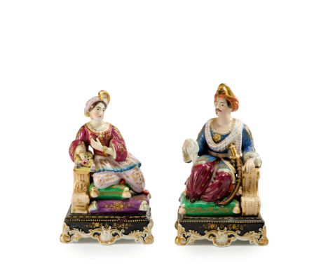 A pair of orientalist porcelain figures : a seated sultan and sultana,  Possibly France, late 19th century, The first wearing