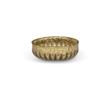 A gilt-copper gadrooned bowl (tombak),  Ottoman Turkey, late 18th century, On plain base, the slightly rounded body rising to