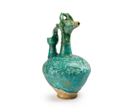 An incised and moulded turquoise blue glazed revival ware pottery ewer,  Ilkhanid-style, Iran, 20th century On conical foot, 