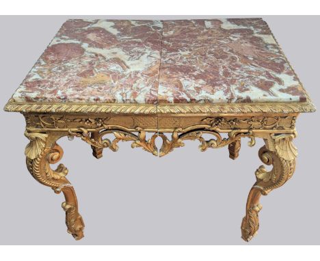 A Louis XV style giltwood centre table, red marble top, (marriage of two console tables), H.98cm W.72cm D.62cm