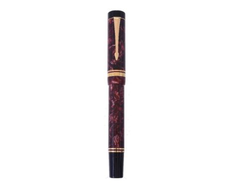 Parker, Duofold Centennial, a red marbled fountain pen, the cap with gilt arrow clip and double cap band, the oblique broad n