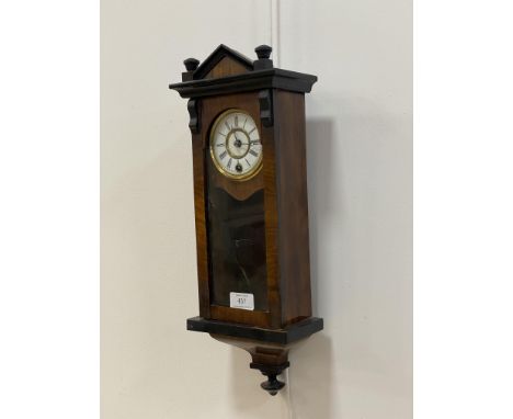 A late 19th century miniature wall clock, the glazed, ebonised walnut case enclosing a white enamel dial with Roman chapter r