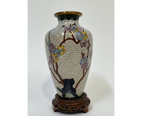 A modern Chinese cloisonne enamel vase with decoration of prunus blossoms and a butterfly amidst background cloud motifs, wit