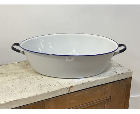 A large twin handled white and blue enamel basin, D65cm (enamel in very good condition with few losses)