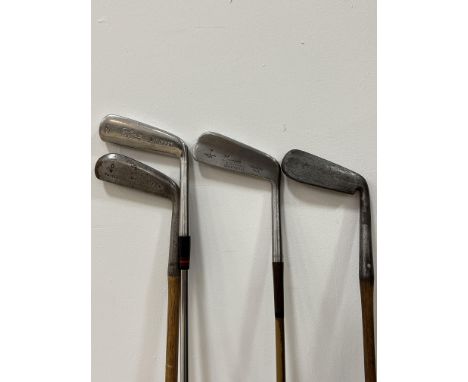 A group of four vintage golf clubs with wooden/steel shafts comprising a Forgan St Andrews Gold Medal putter, a Hillman Speci