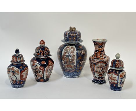 A group of Imari porcelain comprising four lidded jars variously decorated in cobalt blue and red/orange with floral scenes (