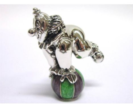 A SILVER AND RESIN DECORATED MODEL OF A CIRCUS CLOWN balancing a ball, London import 2002, 4.7cm tall