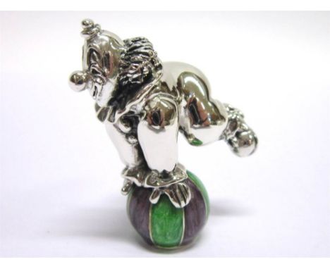 A SILVER AND RESIN DECORATED MODEL OF A CIRCUS CLOWN balancing a ball, London import 2002, 4.7cm tall