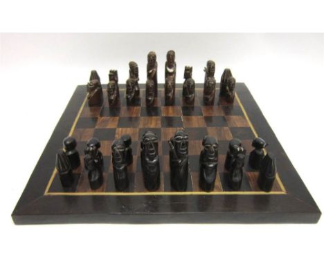 A SOUTH AFRICAN HARDWOOD CHESS SET the kings approximately 10.5cm high, the board 47.5cm x 47.5cm.