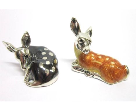 A SILVER AND RESIN DECORATED MODEL OF A RECUMBENT DEER 3.5cm long; with another in an oxidised type finish, 3.2cm long