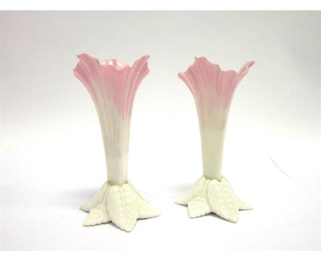 A PAIR OF ROYAL CHINA WORKS, WORCESTER PORCELAIN FLARED SPILL VASES with the base in the form of overlapping leaves, G365 mar