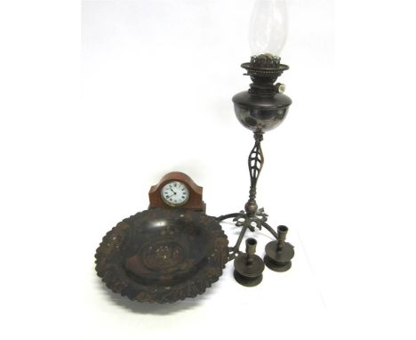 AN OIL LAMP on a cast metal stand; together with a pair of brass dwarf candlesticks; a Japanese papier-mache dish; and a maho