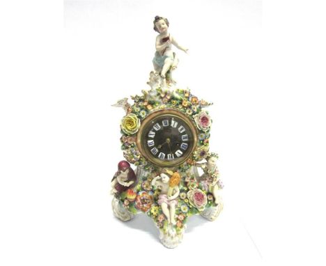 AN AUSTRIAN PORCELAIN MANTLE CLOCK scroll supports with gilt detail to the clock body, encrusted with floral and foliage deco