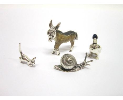 A SILVER AND RESIN DECORATED MODEL OF A DONKEY London import 2004, 3.9cm long; with a silver and resin decorated model of a d