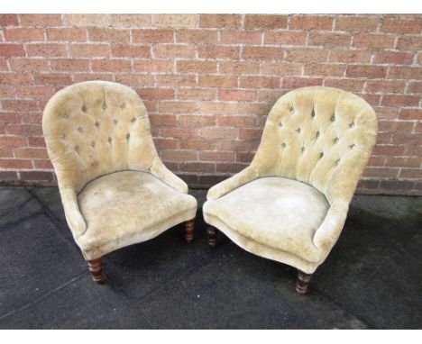 A PAIR OF VICTORIAN BUTTON BACK NURSING CHAIRS upholstered in beige and on turned frontal supports